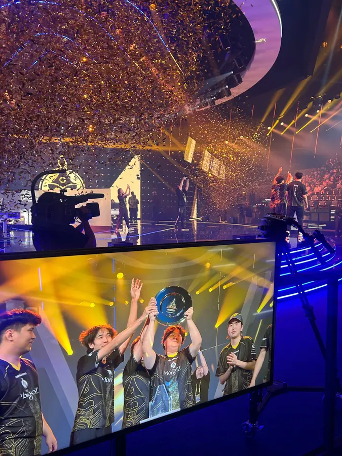 Team lifting the trophy on stage